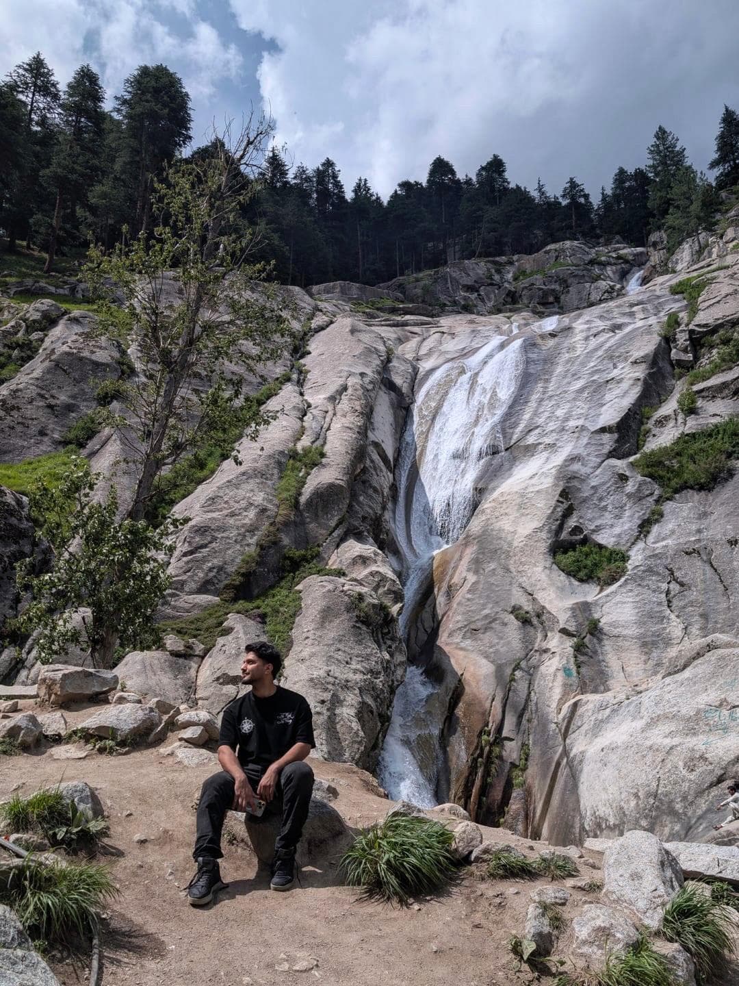 Traveller at the Kumrat waterfall cascading through granite rocks